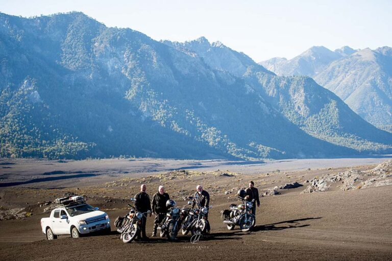 Motards et pickup d'assistance au bord d'un lac de Patagonie lors d'un voyage moto accompagné